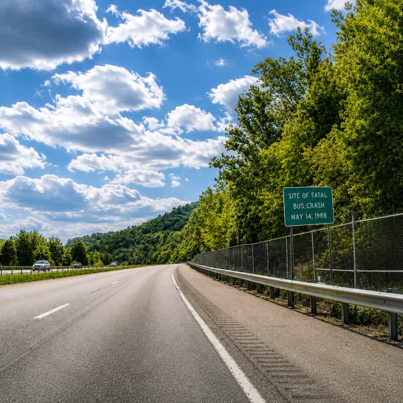 Southbound Interstate 71 near Carrollton, Kentucky, with the roadside sign marking the site of the fatal May 14, 1988 bus crash.